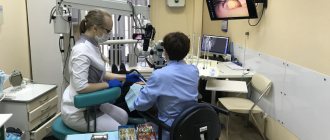 endodontist treats teeth under a microscope