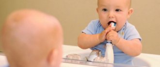 Baby trying to brush his teeth